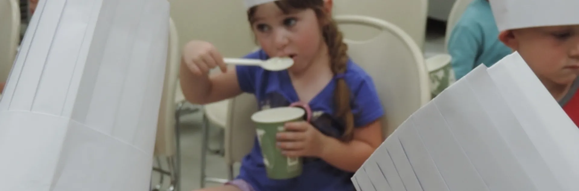 Student taste testing chicken soup