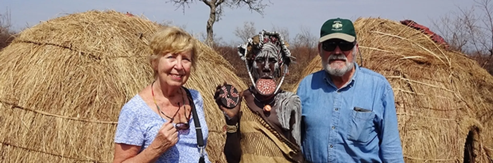 James R. Carey, UC Davis distinguished professor of entomology and his wife, Patty, with a Mursi woman (Ethiopia) showing her lip plate. Also known as a lip disc, it is a status symbol among the Mursi women.