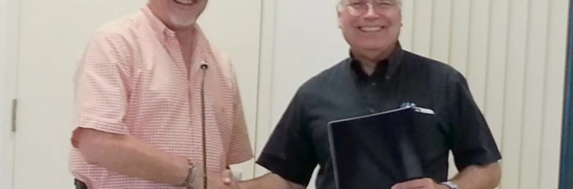 It's all smiles as Director Jeff Dahlberg congratulates David Grantz on his retirement after 29 years.