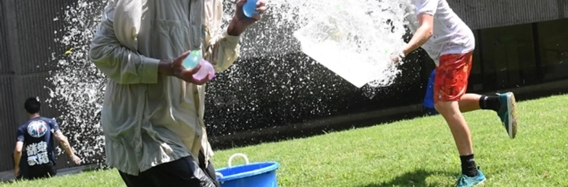 Undergraduate biological sciences major Andrew Kisin of the Aldrin Gomes lab, UC Davis Department of Neurbiology, PHysiology and Behavior, tosses a container of water at Bruce Hammock, UC Davis distinguished professor. (Photo by Kathy Keatley Garvey)