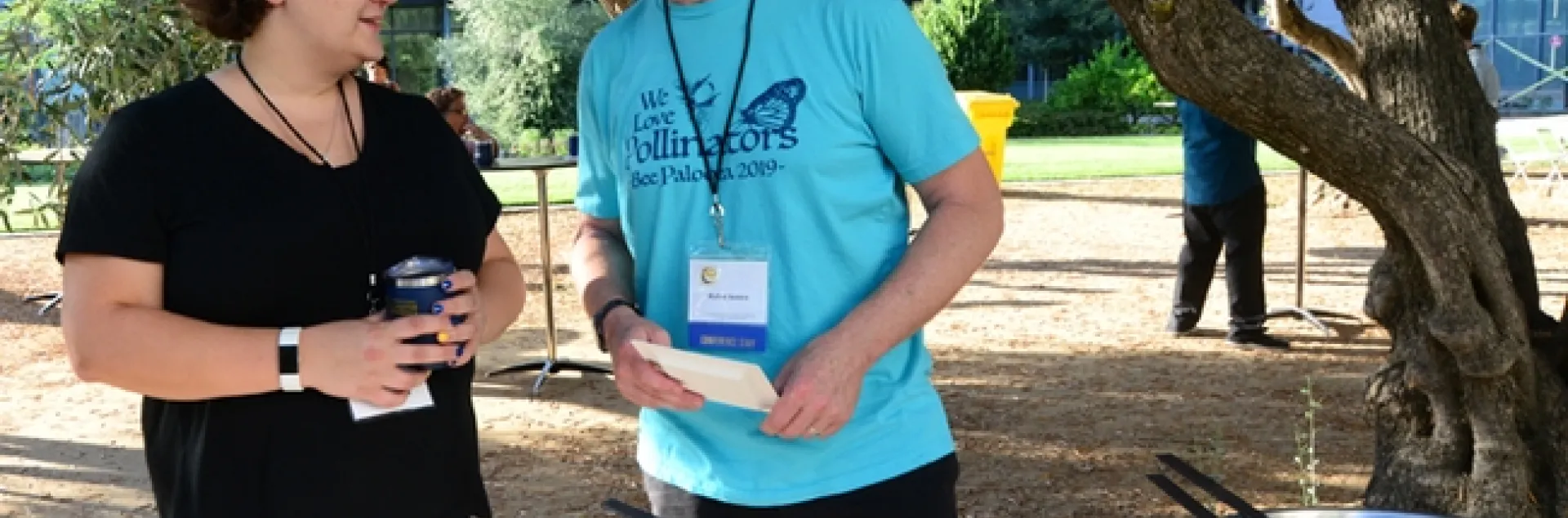 Extension piculturist Elina Lastro Niño of the UC Davis Department of Entomology and Nematology chats with the International Pollinator Conference co-founder Rufus Isaacs of Michigan State University at the Thursday reception. (Photo by Kathy Keatley Garvey)