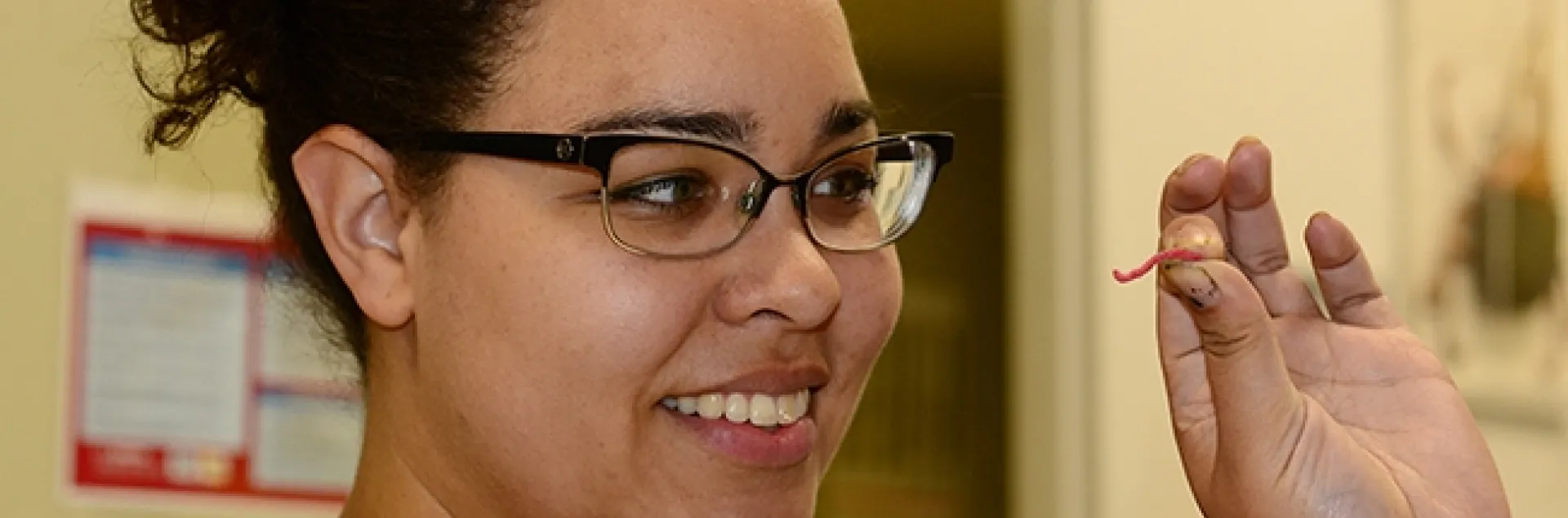 Biologist Iris Bright checks out a red earthworm, one of the items available for sampling at the Bohart Museum of Entomology's open house on Sept. 21. (Photo by Kathy Keatley Garvey)