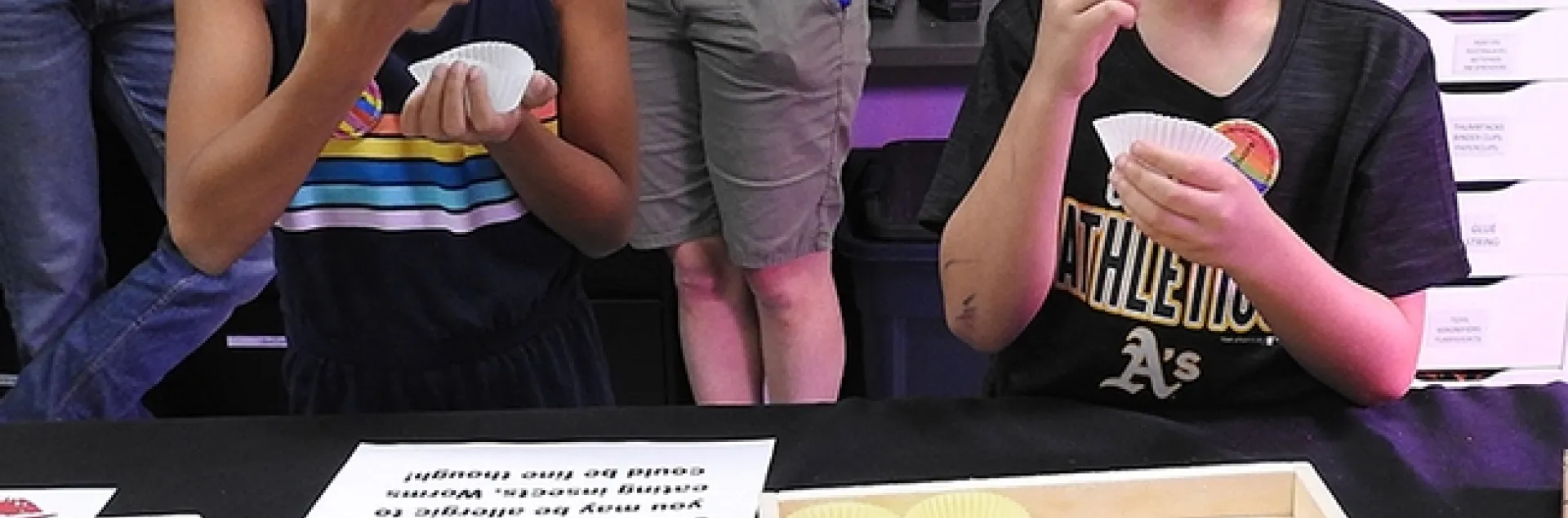 Cousins Aryanna Nicole Torres, 8, of Woodland and Aaden Matthew Brazelton, 8, of Vacaville, get ready to eat insects. Their grandmother, UC Davis employee Elvira Galvan Hack of Dixon, accompanied them to the museum. (Photo by Kathy Keatley Garvey)