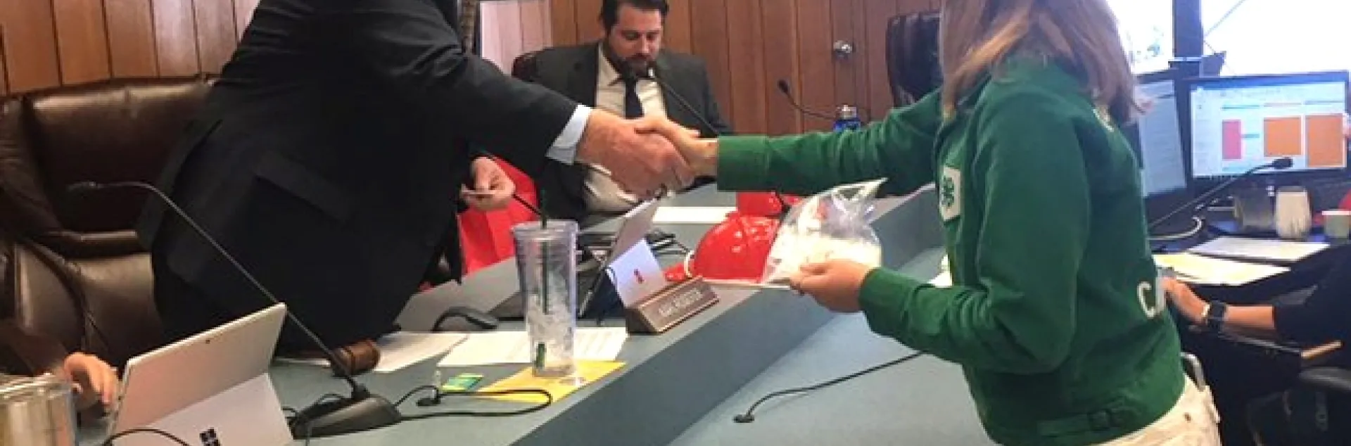 Board Chair, Supervisor Karl Rodefer shaking the hand of Belle, Tuolumne County Ambassador