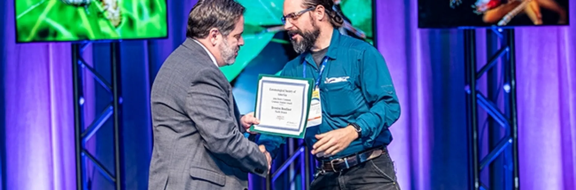 UC Davis doctoral candidate Brendon Boudinot walks on stage to receive the John Henry Comstock Award, given by the Pacific Branch, Entomolgical Society of America. (ESA Photo)