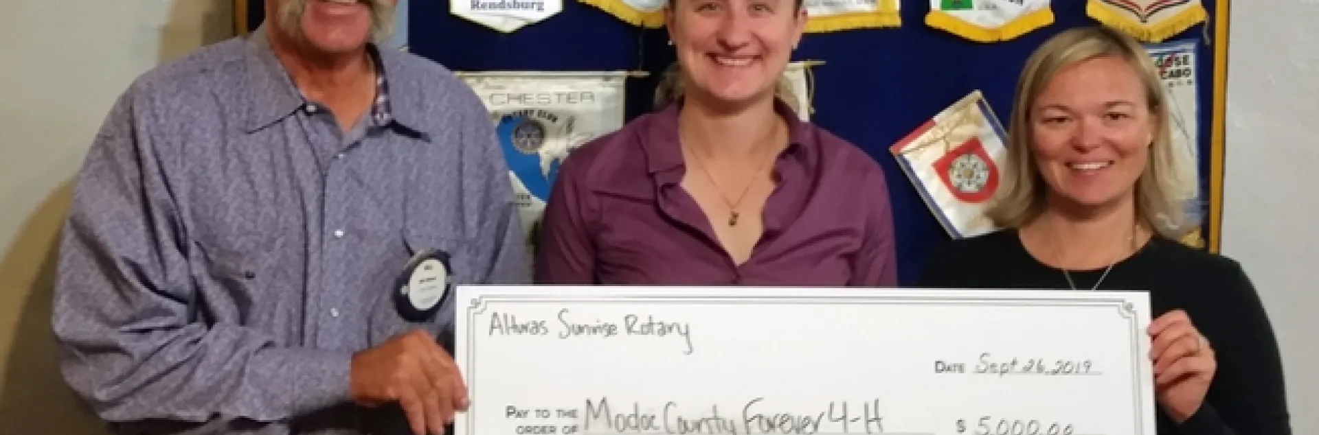 Bill Wilson, Alturas Sunrise Rotary president, with UCCE director Laura Snell, and Sadie Camacho, 4-H program representative.