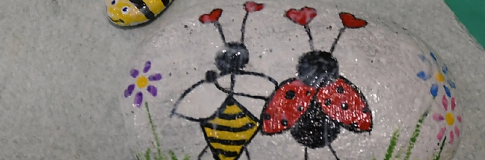 These rocks at the Bohart Museum of Entomology depict favorite insects: honey bees and ladybugs (lady beetles.) The larger rock, inspired by Valentine's Day, is titled "Love Bugs." (Photo by Kathy Keatley Garvey)
