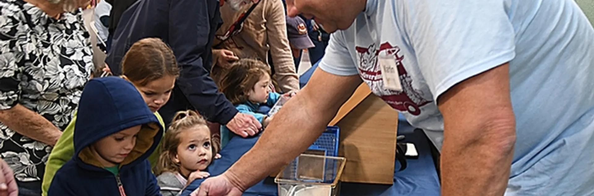 Martin Hauser, senior insect biosystematist with the Plant Pest Daignostics Branch, California Department of Food and Agriculture, shows Madagascar hissing cockroaches to visitors. (Photo by Kathy Keatley Garvey)