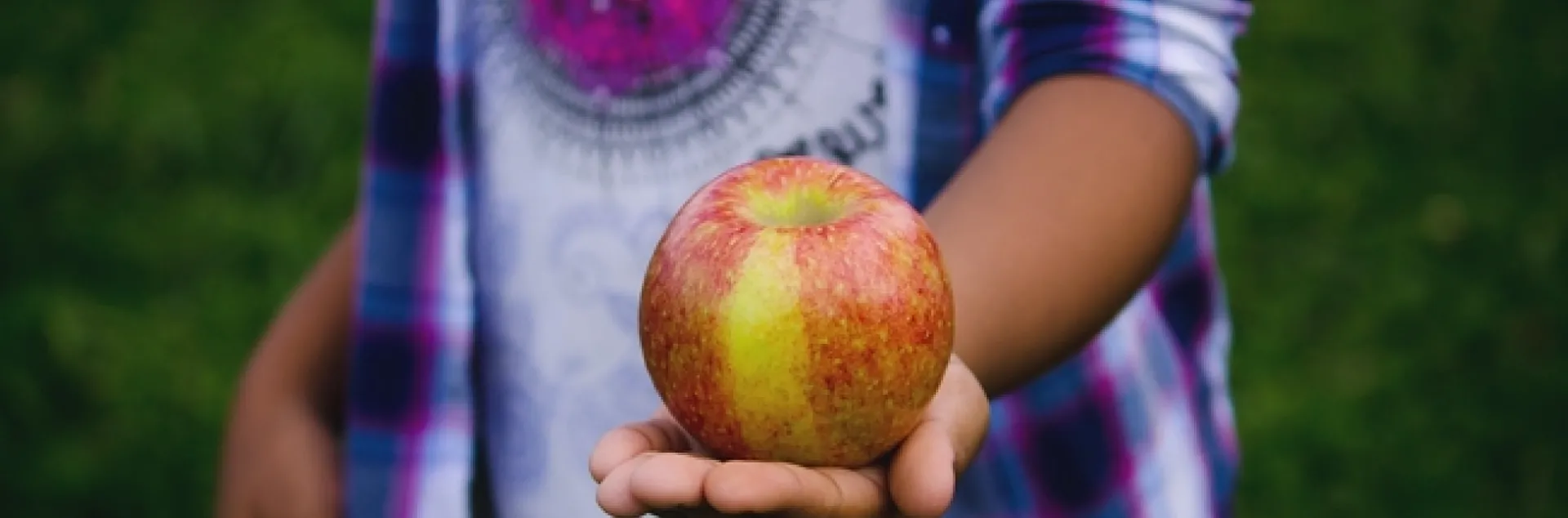 Child holding apple.