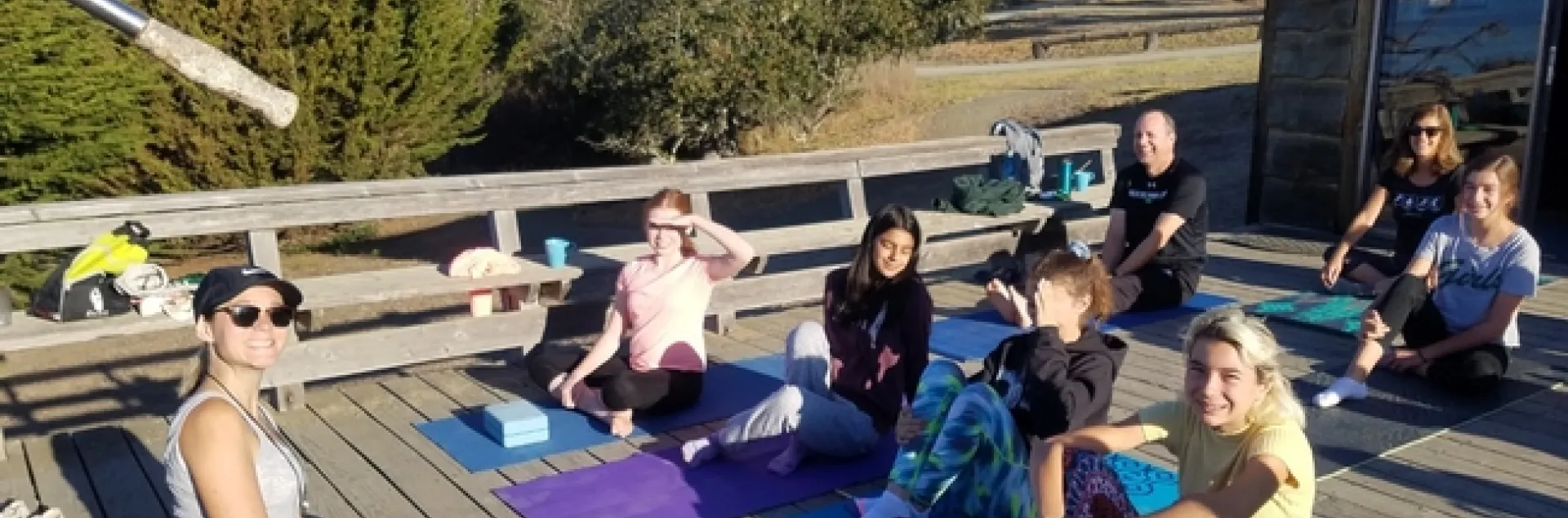 People outside on exercise mats looking up at the camera