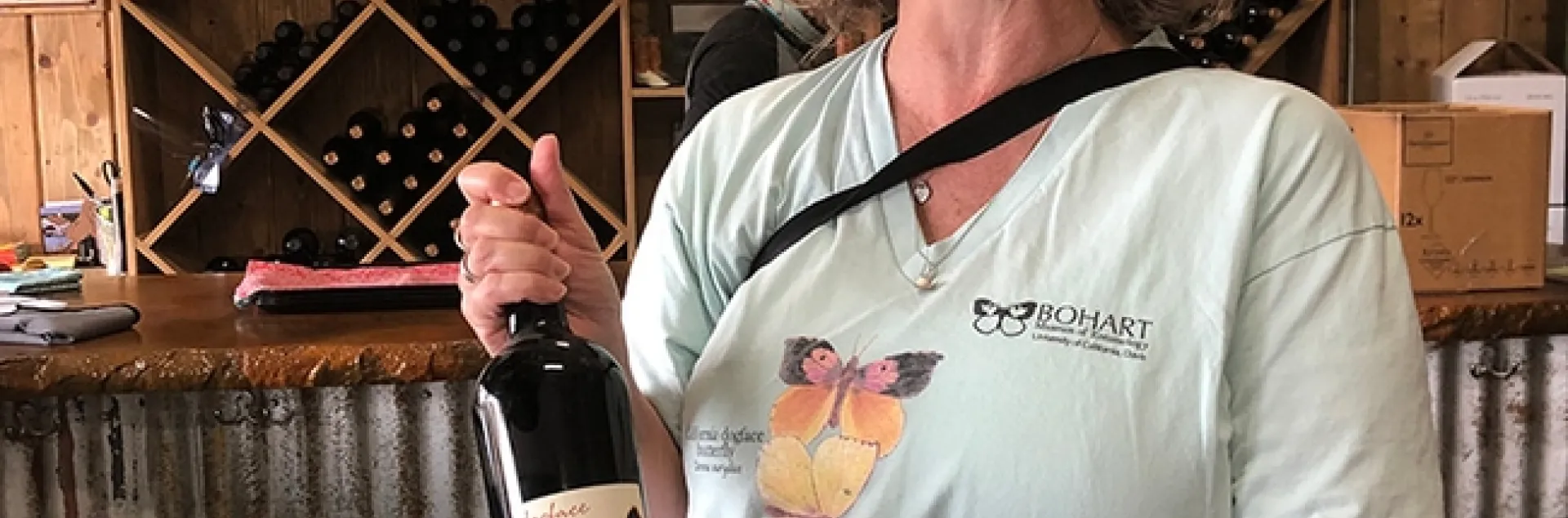 Professor Fran Keller of Folsom Lake College with a bottle of Dogface Cabernet Sauvignon produced by Lone Buffalo Vineyards and Winery, Auburn. Sales of the wine help conservation efforts of Placer Land Trust to protect the butterfly, the California state insect.