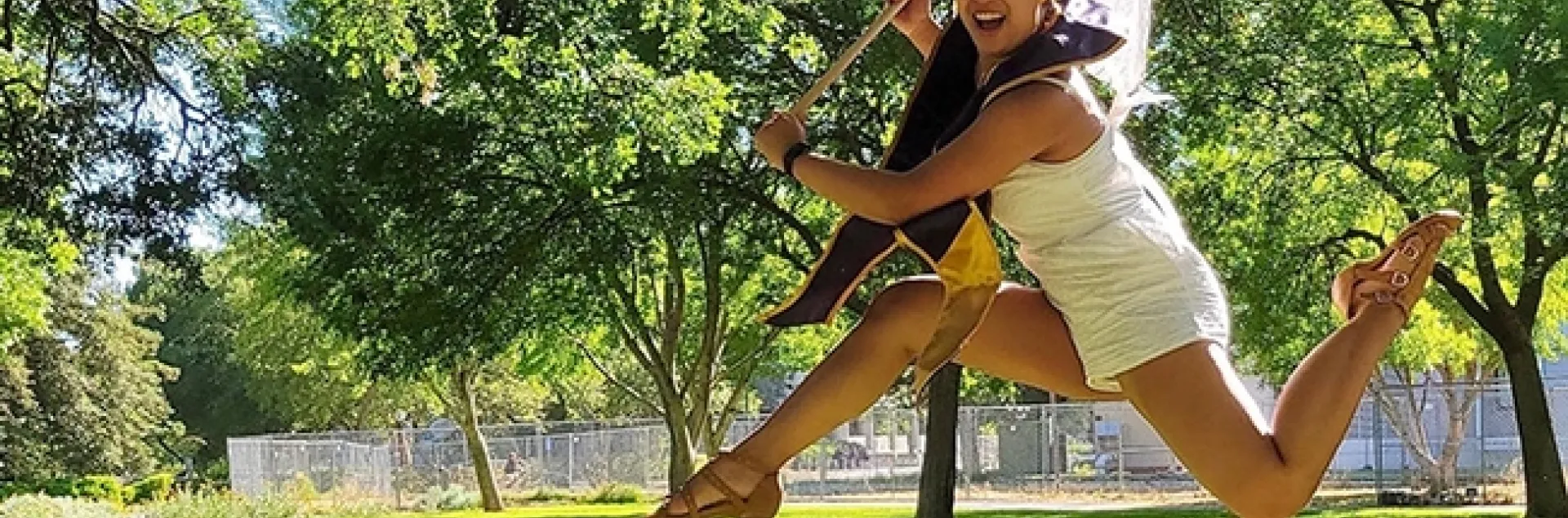 This image of UC Davis entomology graduate RJ Millena shows her jumping for joy while wielding an insect net. (Photo by Kaylee Fagan)