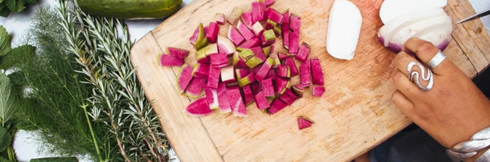 Vegetables being sliced up on a cutting board