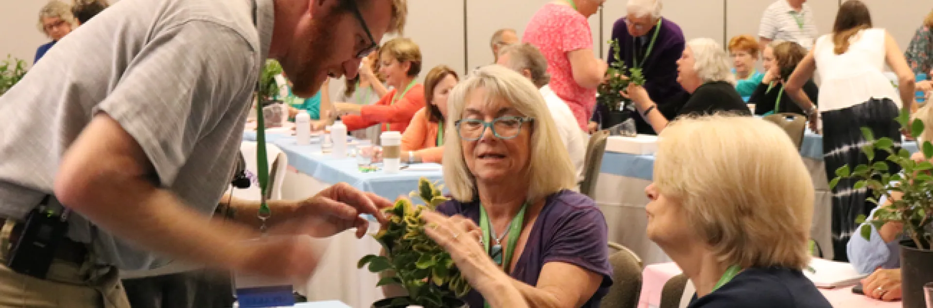 Attendees at a UC Master Gardener traiing looking at a plant