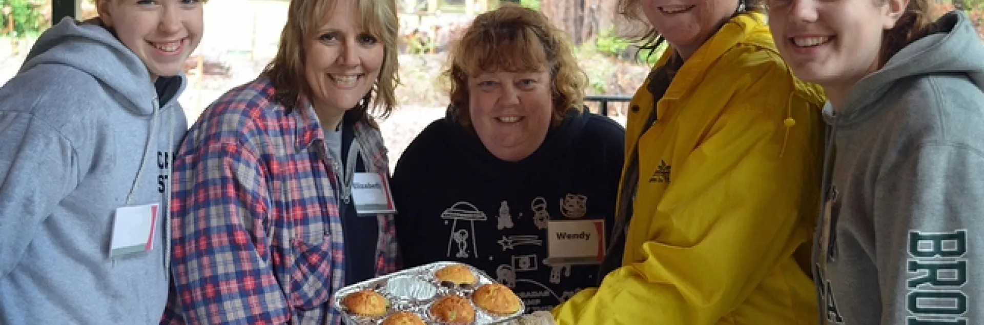 Five women with muffins