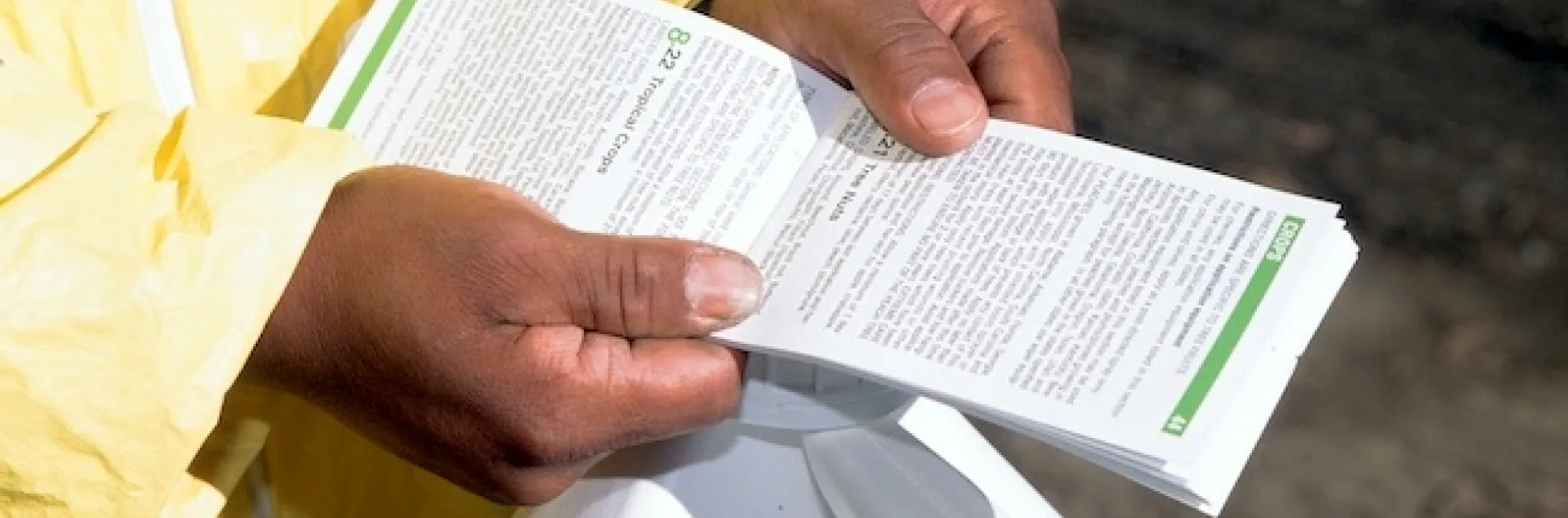 Person reading an open pesticide label booklet.