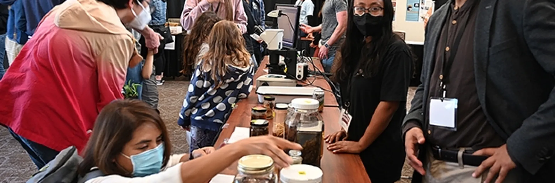 Three nematologists kept busy at their booth at the UC Davis Biodiversity Museum Day. In front is coordinator Shahid Siddique, assistant professor, and his doctoral students Pallavi Shakya (nearest him) and Alison Coomer. In the back (far right) is Rob Blundell, not part of the lab, but who assisted. (Photo by Kathy Keatley Garvey)