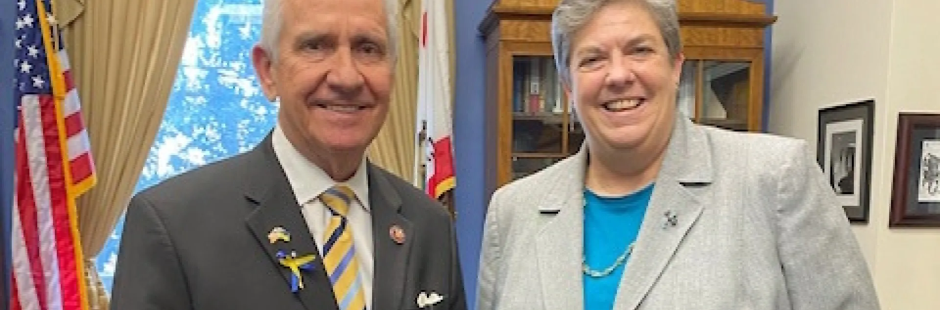 Jim Costa, left, poses beside Glenda Humiston in his office. A U.S. flag hangs behind his shoulder.