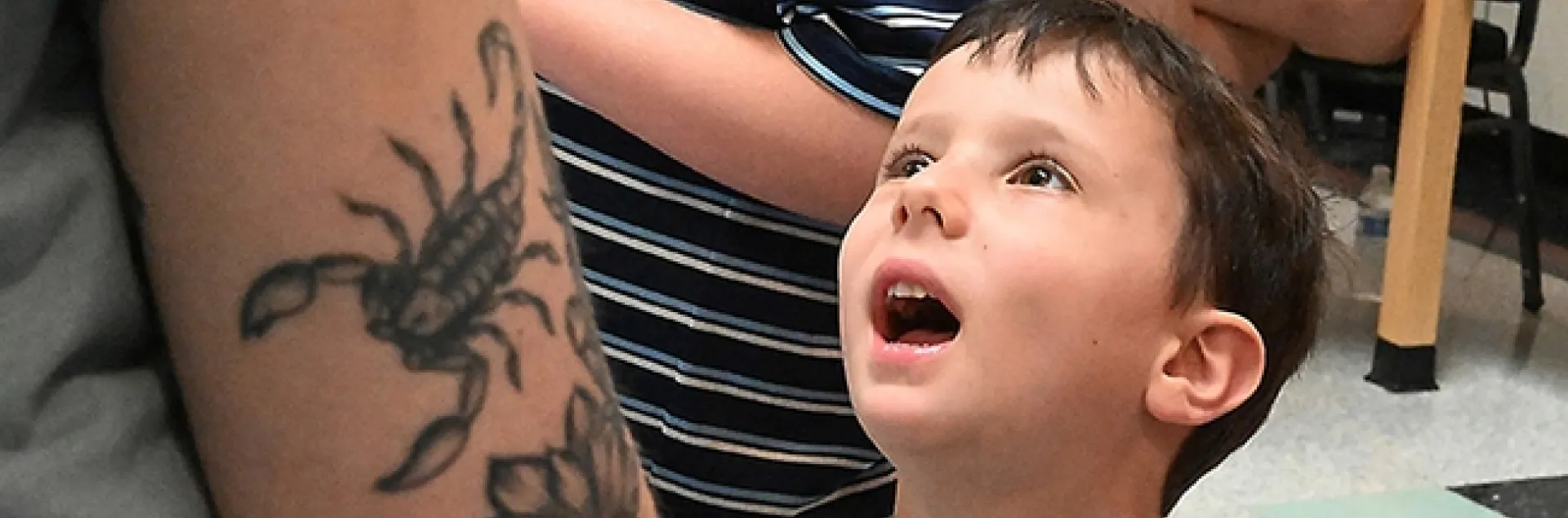 Shaked Hoffman, 5, of Davis, listens intently to an arachnologist talking about spiders. (Photo by Kathy Keatley Garvey)