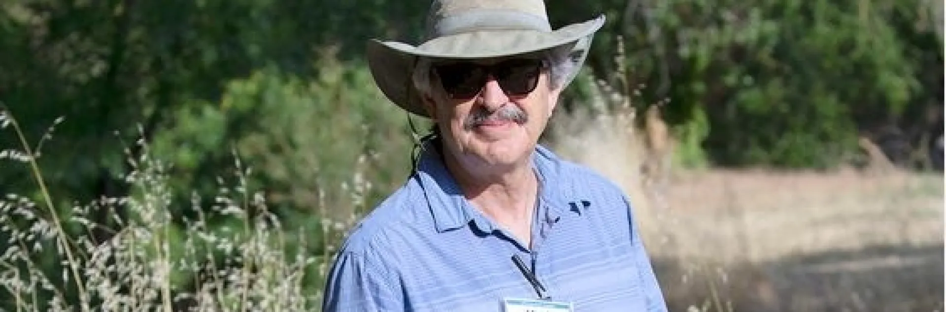 Bell stands in dry grass