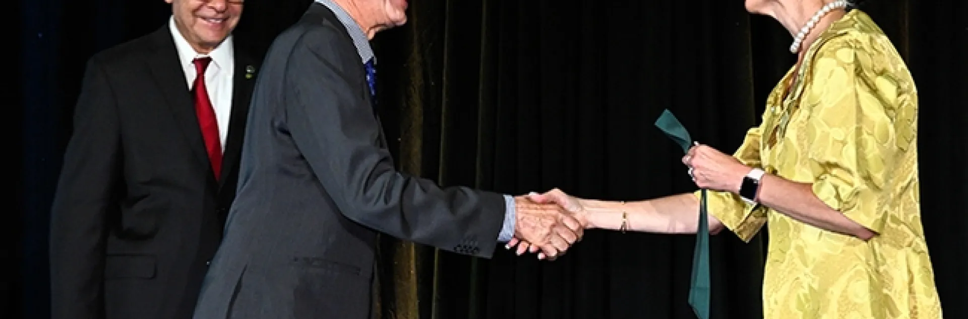 UC Davis distinguished professor Walter Leal, inducted as a Fellow of the National Academy of Inventors, receives congratulations from the NAI's Elizabeth Lea Dougherty, J.D., director of Inventor Education, Outreach, and Recognition in the Office of Innovation Development at the U.S. Patent and Trademark Office. At left is NAI president Paul Sanberg. (Courtesy Photo)