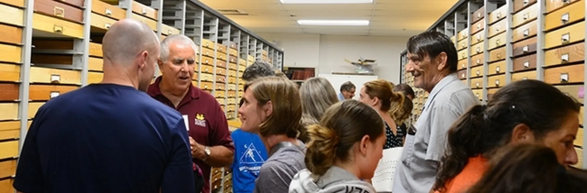 Entomologist Jeff Smith (second from left), curator of the Bohart Museum's Lepidoptera collection, talks to visitors at a recent Moth Night. (Photo by Kathy Keatley Garvey)