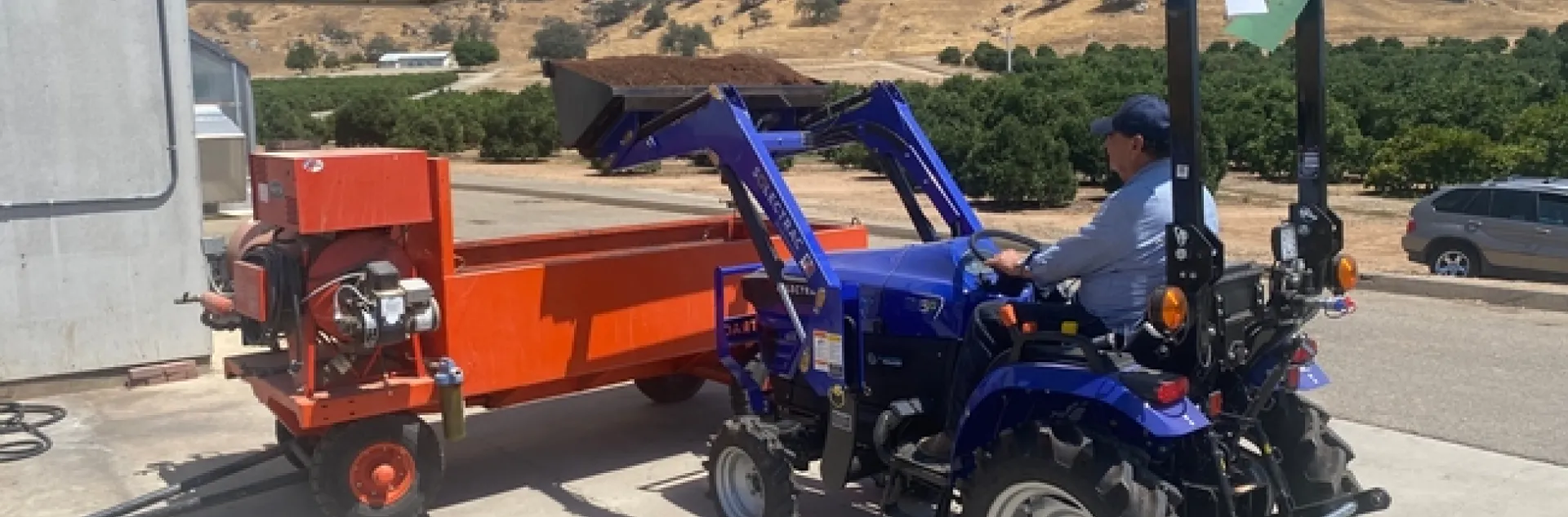 At LIndcove REC, an electric tractor mixes soil for planting trees in the greenhouse.