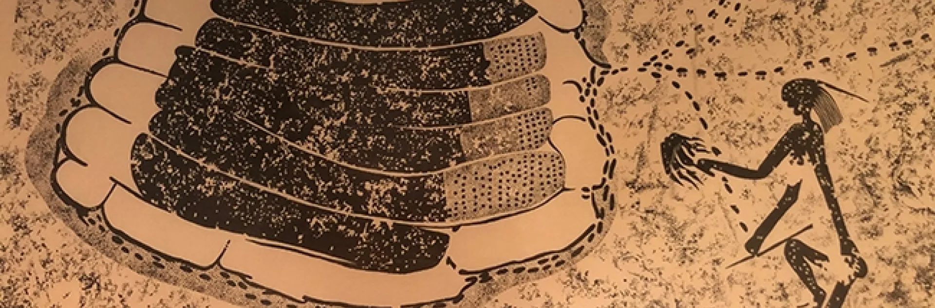 This framed photo of an image, once belonging to the late Extension apiculturist Eric Mussen, shows an ancient rock painting from Zimbabwe. A beekeeper is using a smoker.