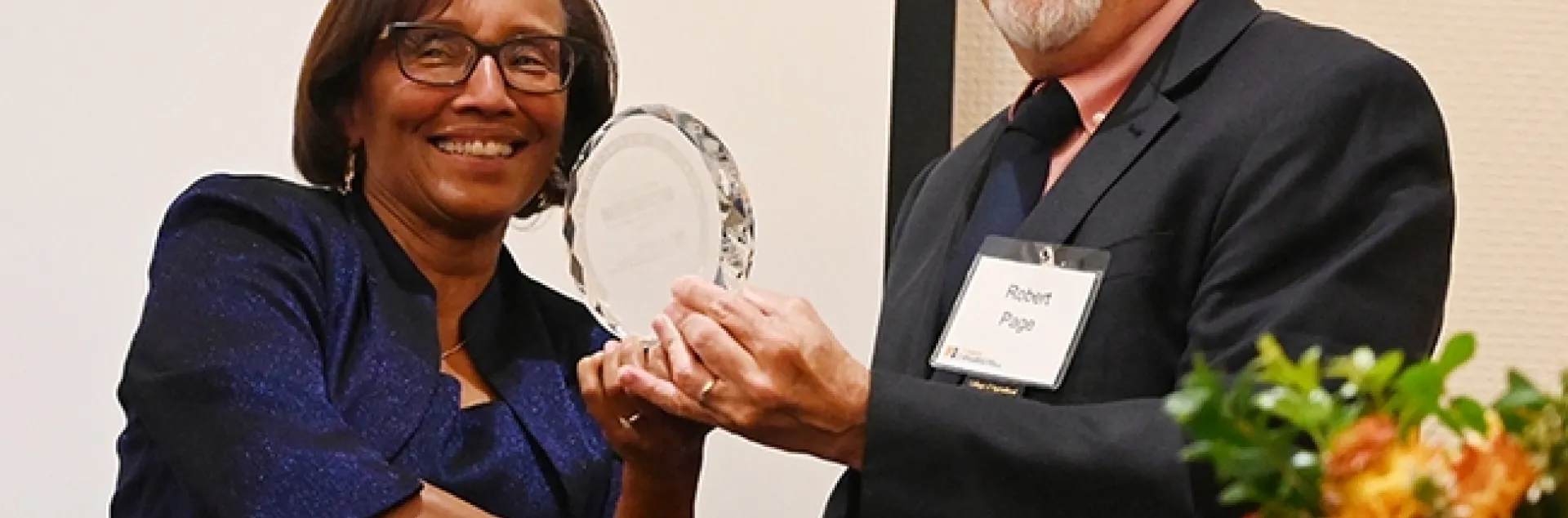 Helene Dillard, dean of the UC Davis College of Agricultural and Environmental Sciences, presents the Exceptional Emeriti Faculty Award to honey bee geneticist Robert E. Page Jr. (Photo by Kathy Keatley Garvey)