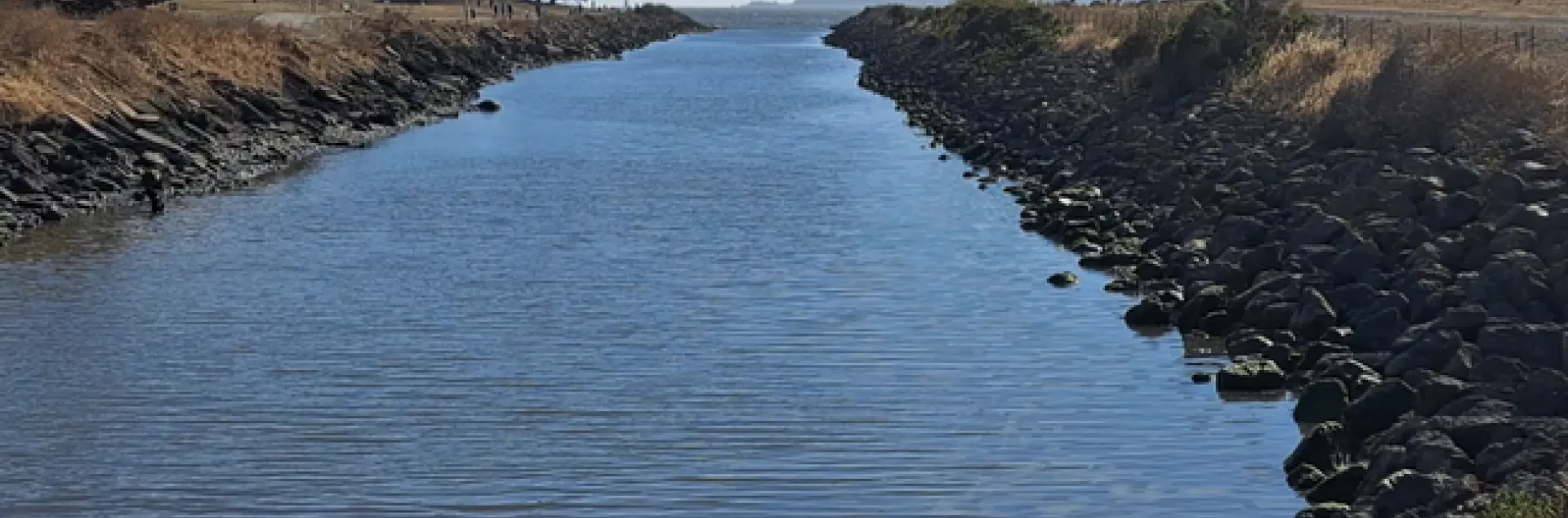 Receiving water flowing out towards San Francisco Bay with Golden Gate Bridge in the distance.