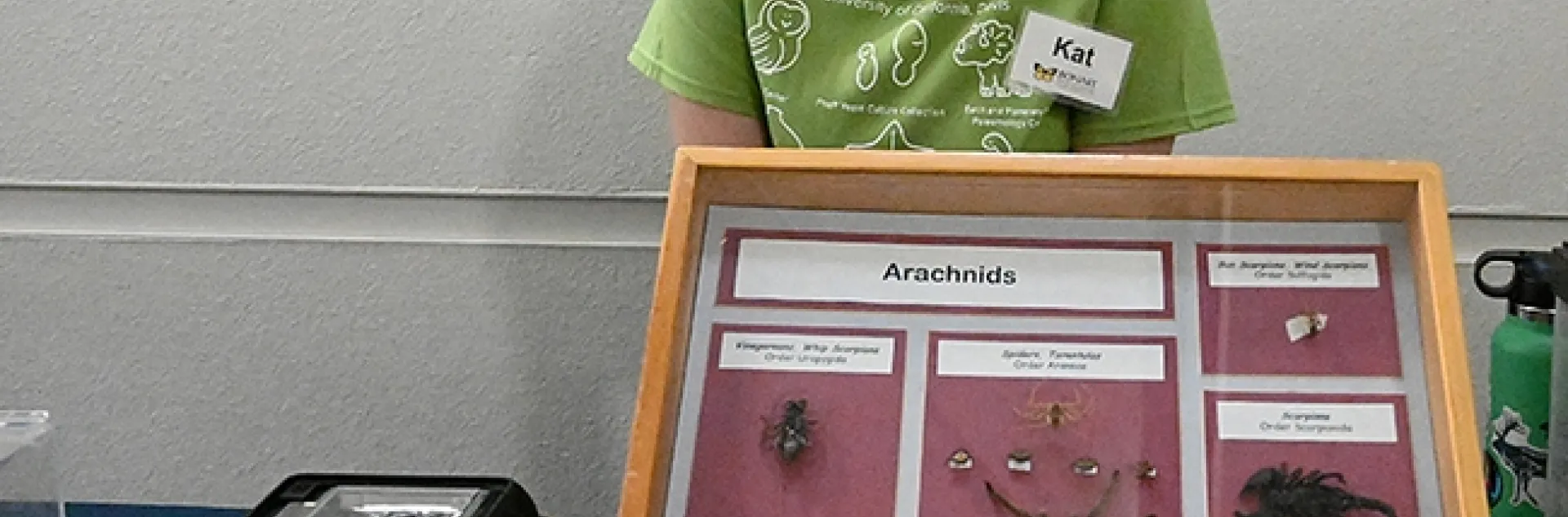 UC Davis entomology freshman student Kat Taylor answers questions at the Jason Bond lab display table. (Photo by Kathy Keatley Garvey)