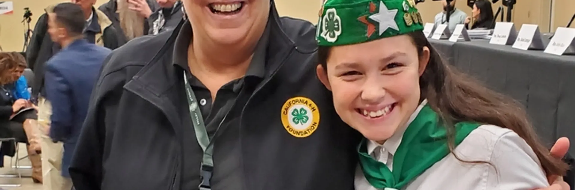 Humiston is wearing a black jacket with a California 4-H Foundation emblem. Kambree is wearing her green and white 4-H uniform.