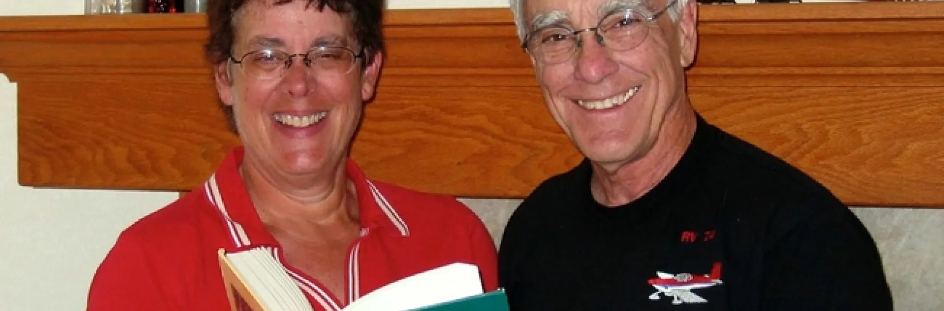 Dave Cudney holds a "Weeds of the West" book with his sister.