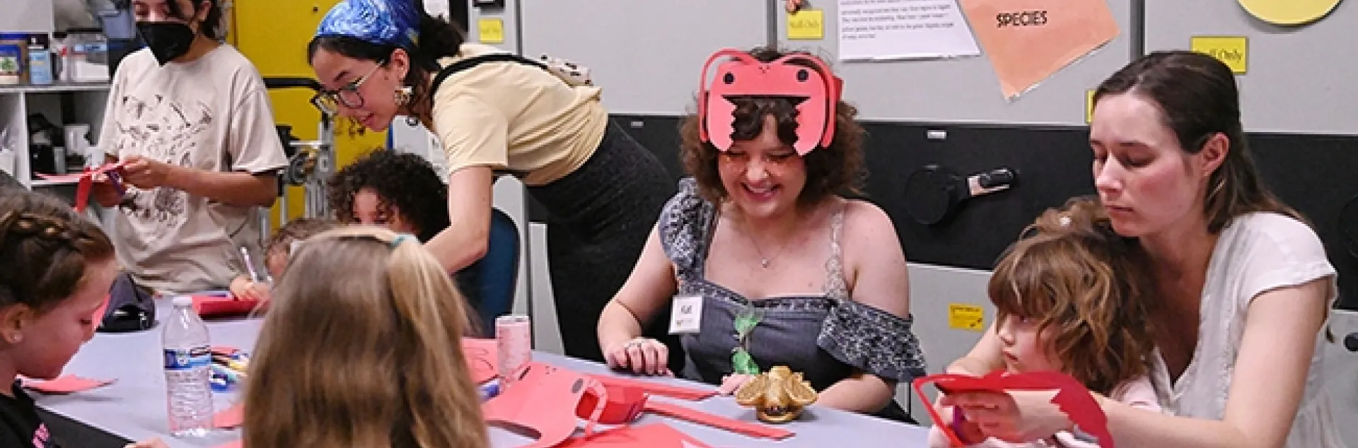 UC Davis first-year entomology student Kat Taylor (in ant headgear) staffed the arts-and-crafts table at the Bohart Museum open house. (Photo by Kathy Keatley Garvey)