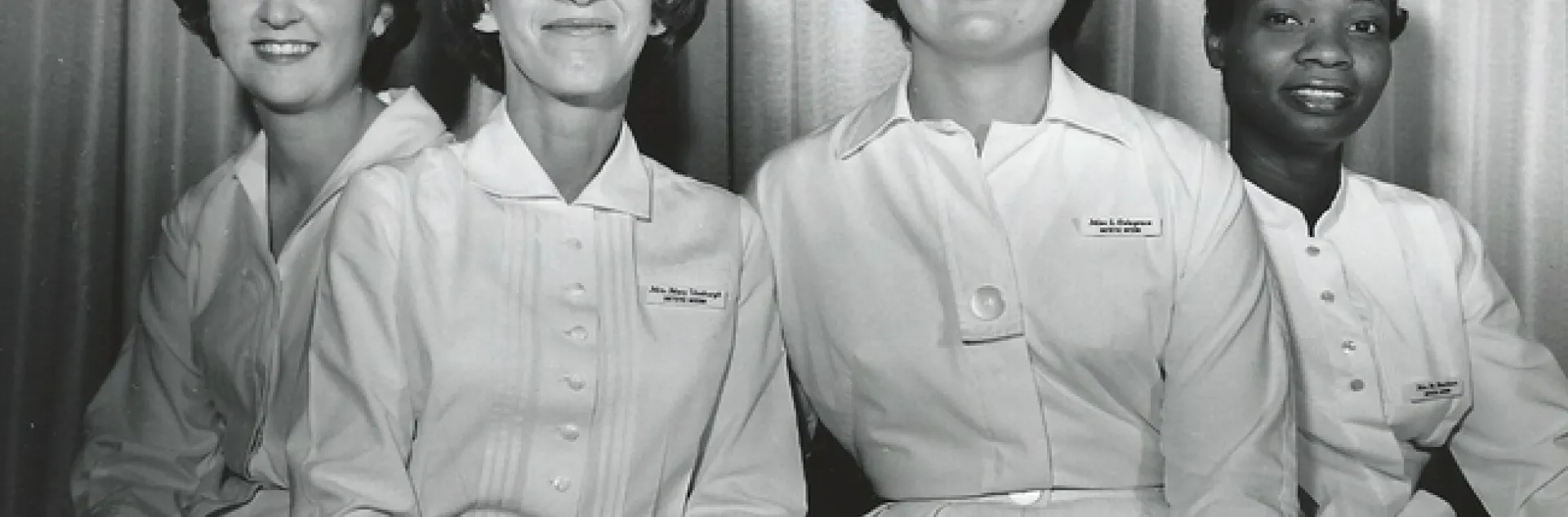 Three Caucasian women and one Black woman