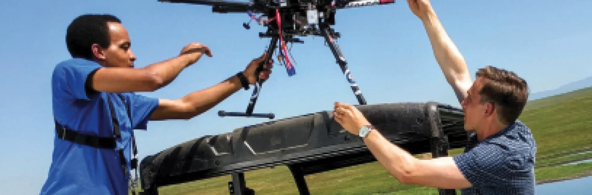 Two guys load a drone into a pickup. Working together for the benefit of all Californians. 2022 UC ANR Annual Report.