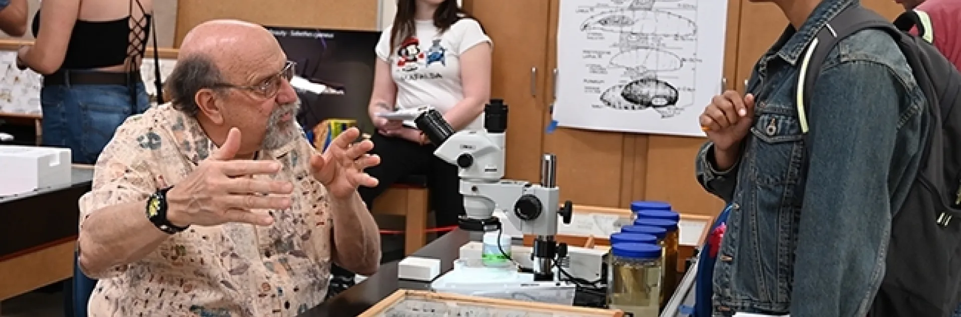 UC Davis forensic entomologist Robert "Bob" Kimsey answering questions at his "Dr. Death" booth in Briggs Hall during the 2023 UC Davis Picnic Day. (Photo by Kathy Keatley Garvey)