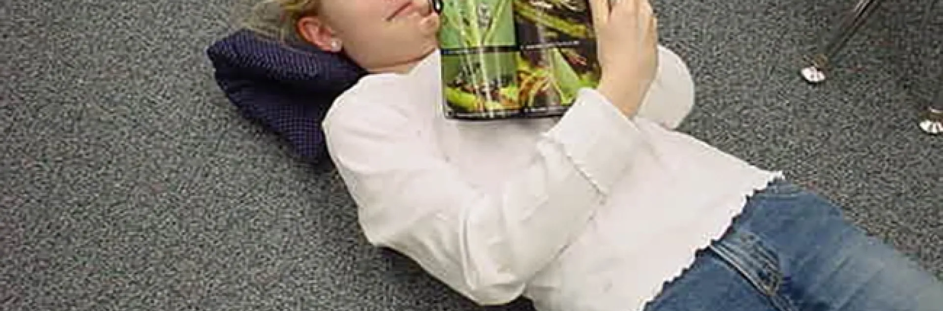 As a third grader, Jill Oberski is stretched out on the floor reading her "Audubon Field Guide to Insects and Spiders of North America." Another insect publication is within reach.