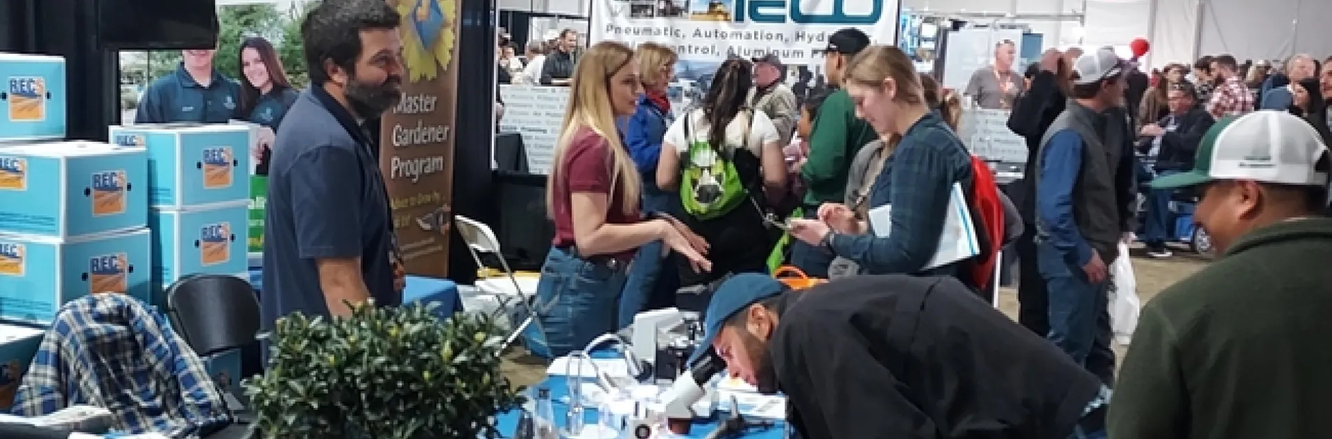 SRAs Brady Holder and Lauren Vuicich provide information from the Kearney booth at World Ag Expo.