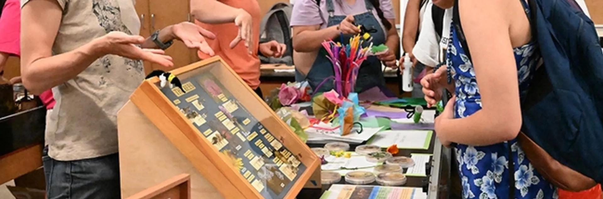 UC Davis community ecologist Rachel Vannette (foreground), associate professor and vice chair of the UC Davis Department of Entomology and Nematology, answers questions at the UC Davis Picnic Day. In back is doctoral candidate Gillian Bergmann, who is advised by Vannette and Johan Leveau. (Photo by Kathy Keatley Garvey)