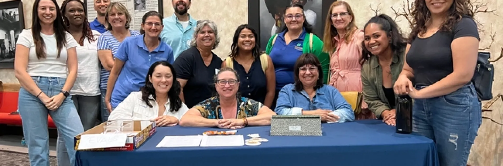 15 people from UC ANR standing aroud the registration table at the Pala Tribal Partnerships workshop
