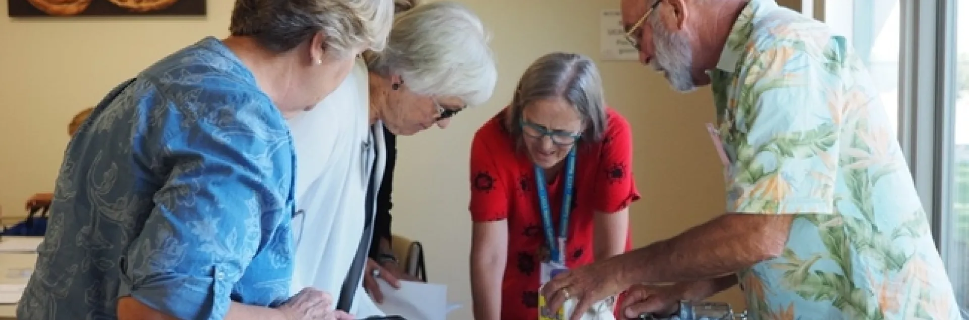 Group of people looking at items on a table