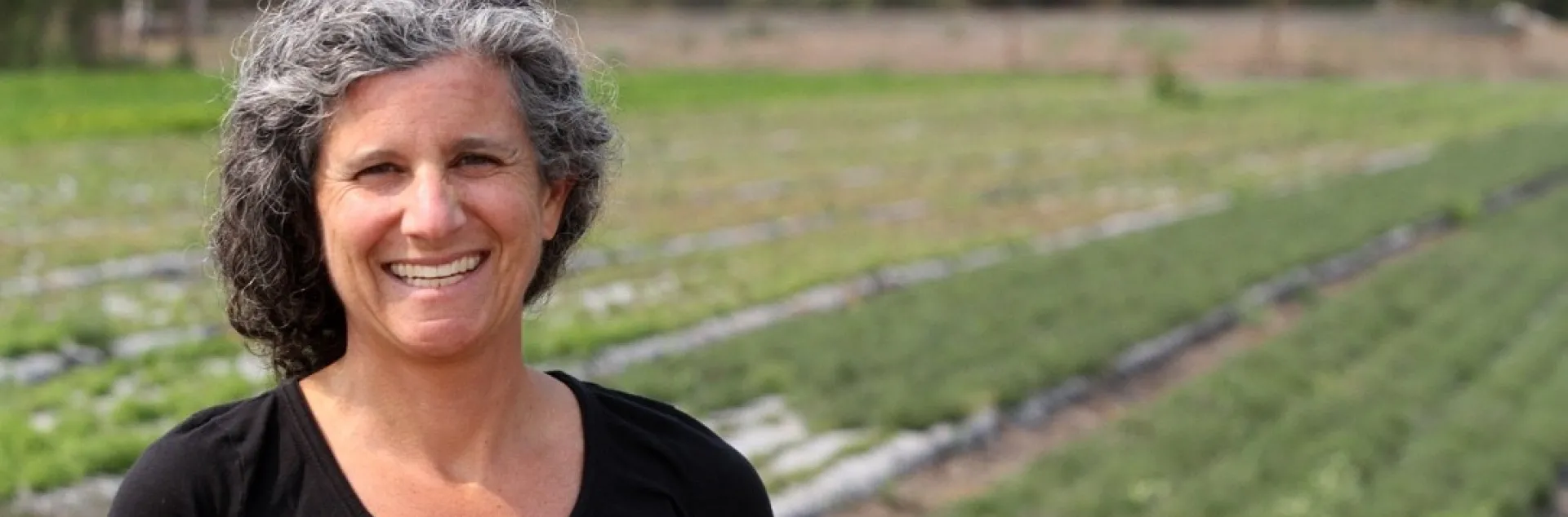 Emily Jane Freed smiles in a field of thyme at Jacobs Farm/del Cabo, Inc. in Santa Cruz County