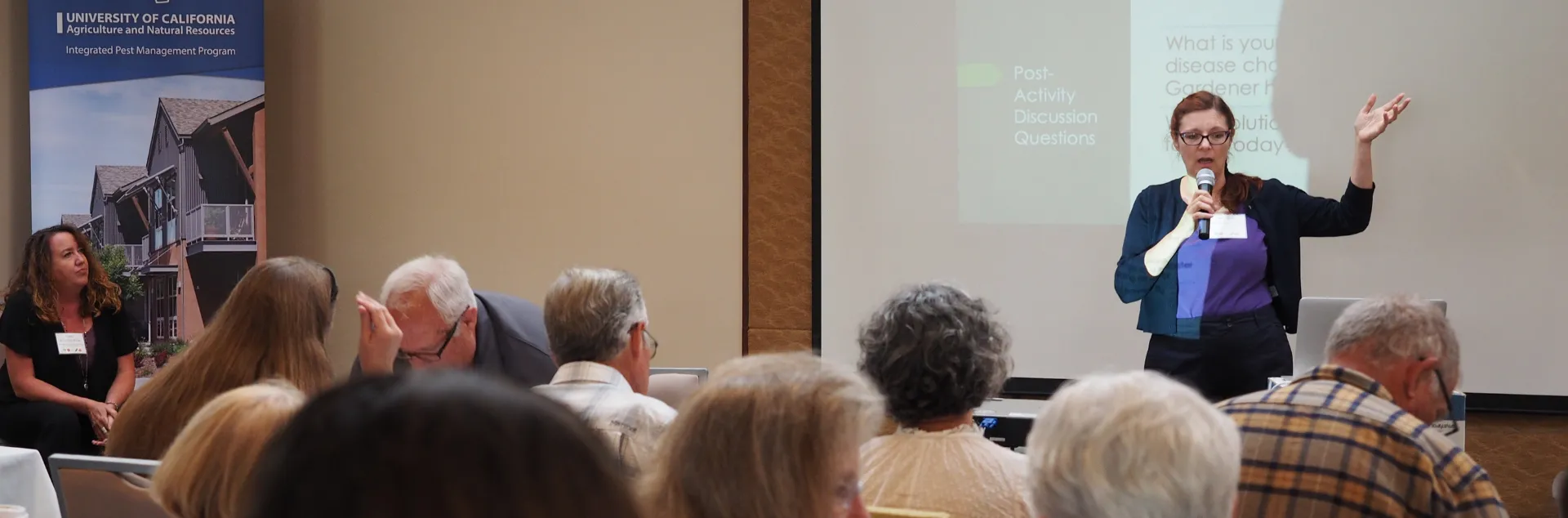 Person lecturing in front of a group of people