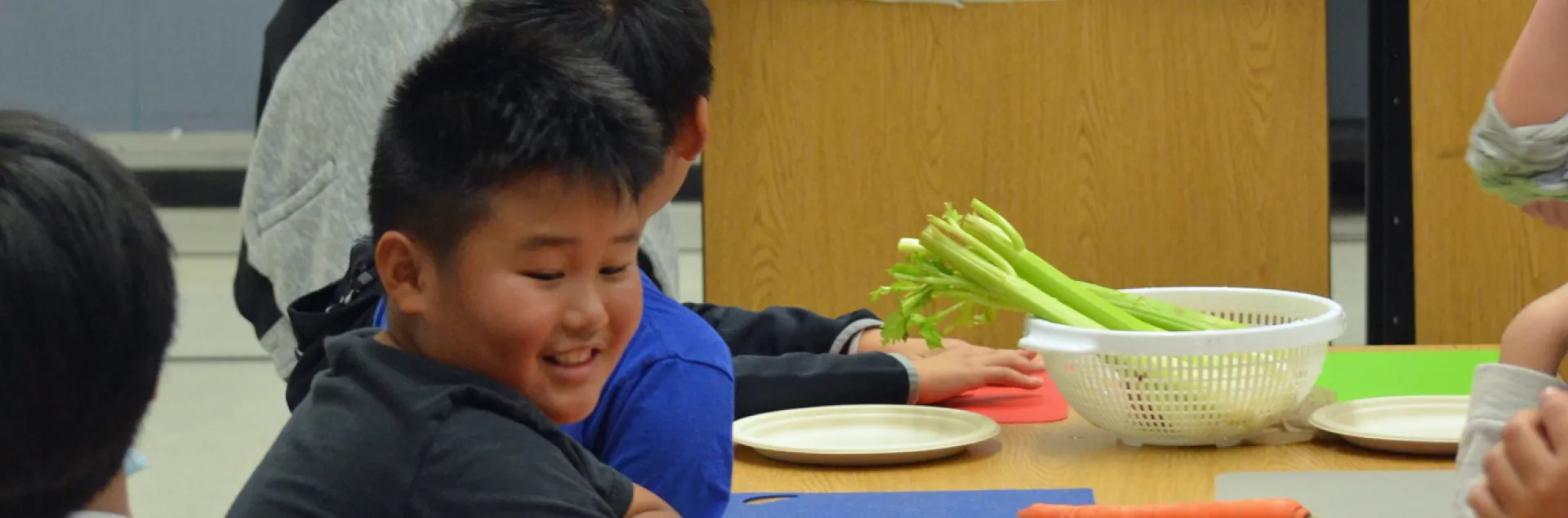 A teen teacher volunteer leads a Cooking Academy lesson at Mary Tsukamoto Elementary School in Sacramento, California.