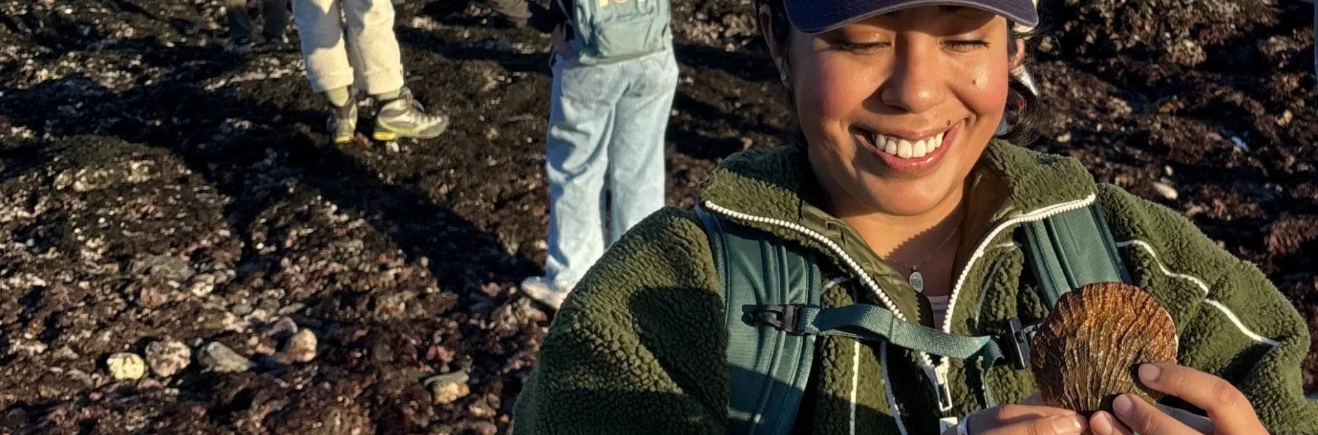 Daisy Prado holds a shell as she explores Duxbury Reef as part of a UC California Naturalist course excursion