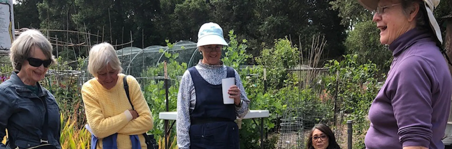 A Master Gardener teaching several people about container gardening