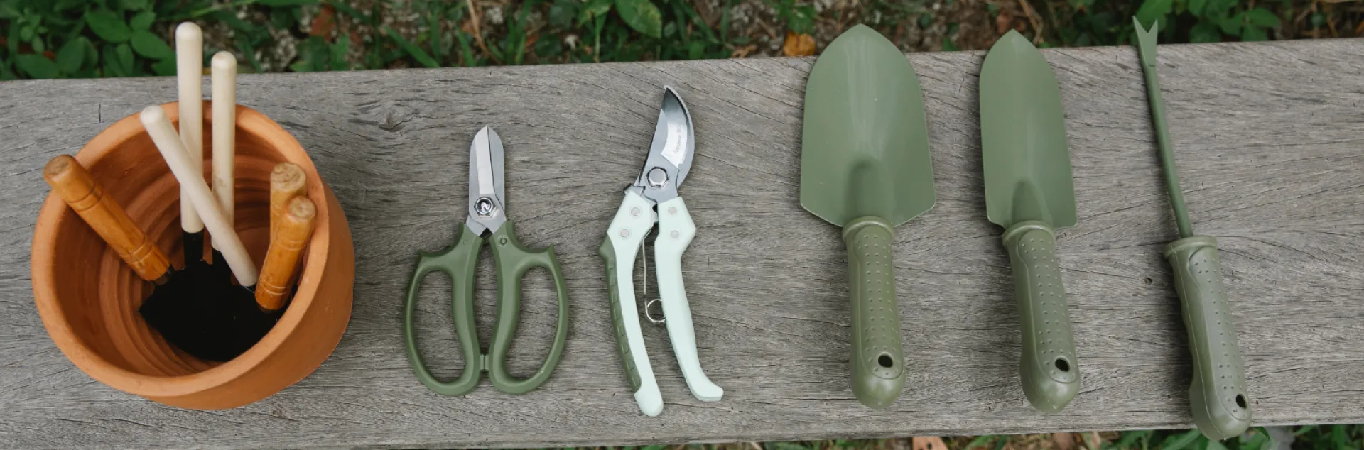 Gardening tools on wooden bench in yard