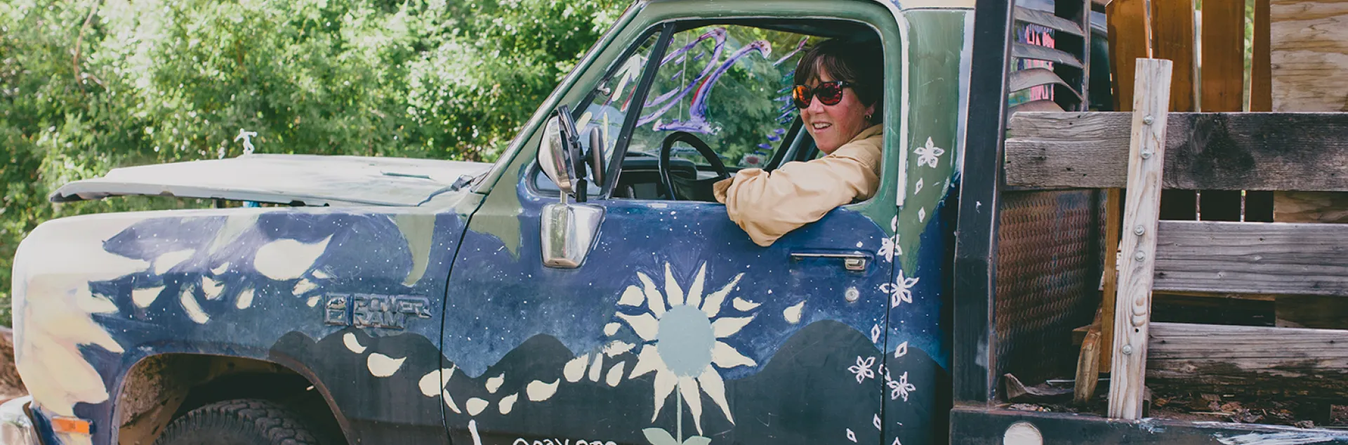 Laurie "Lio" Wayne leans out the driver's side window of a truck at her Locavore Farms
