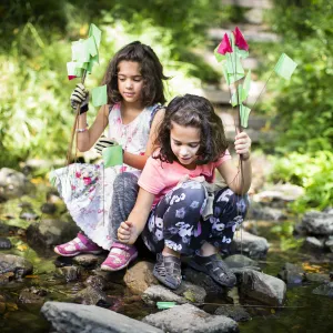 Two youth sitting at water edge